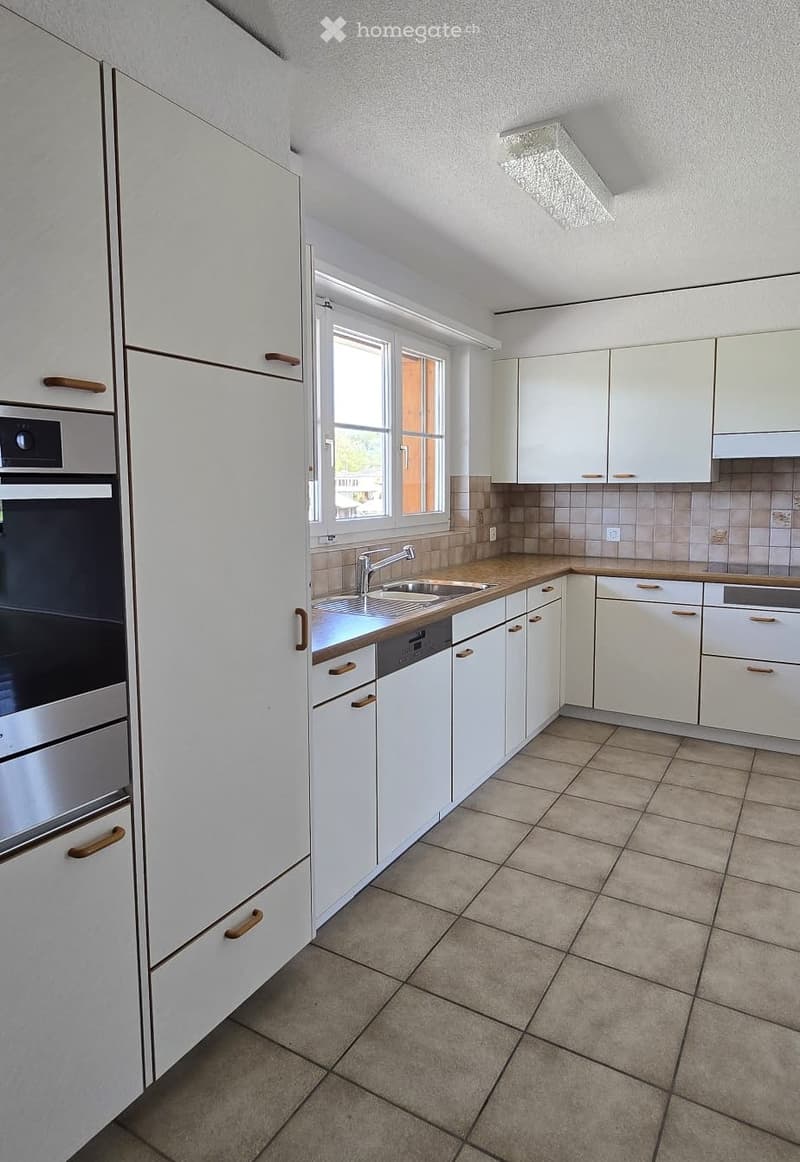 modern kitchen with white cabinets, tiled floor, stainless steel appliances, sink with faucet, dishwasher, oven, window