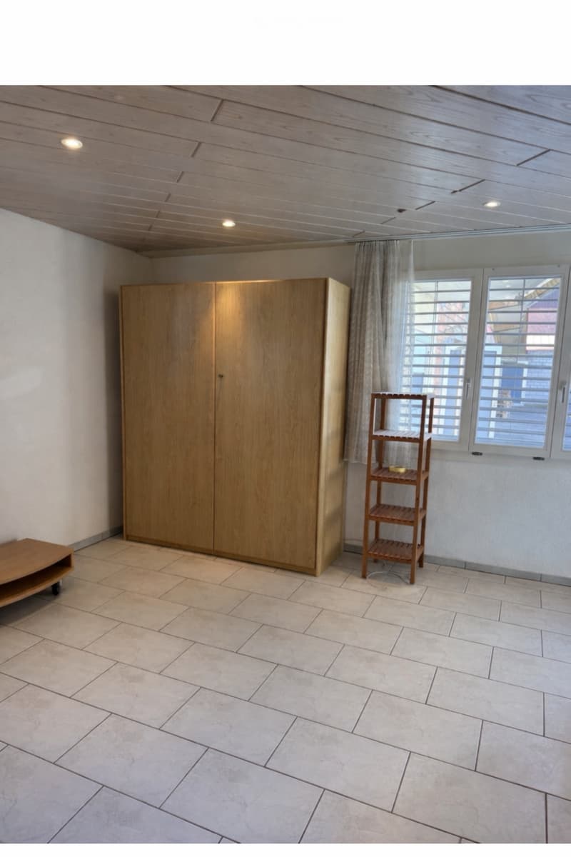 empty room, wooden cabinet, wooden shelf, tiled floor, white walls, window with blinds