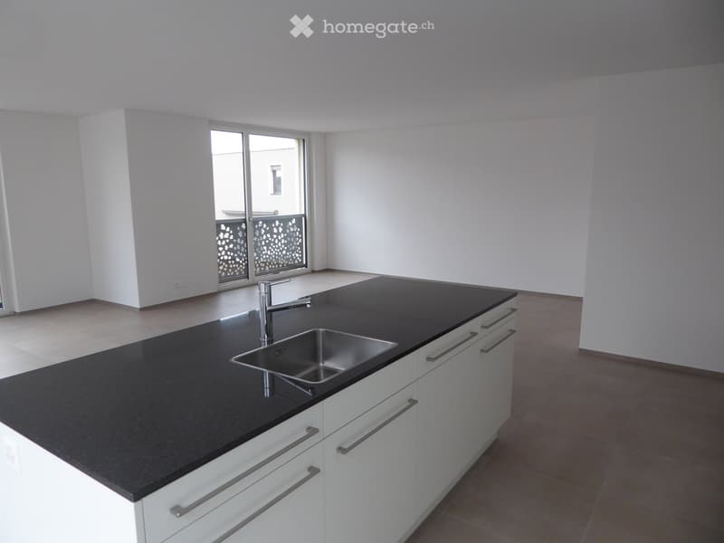 Kitchen. Modern kitchen with white cabinets, black countertop, and stainless steel sink.