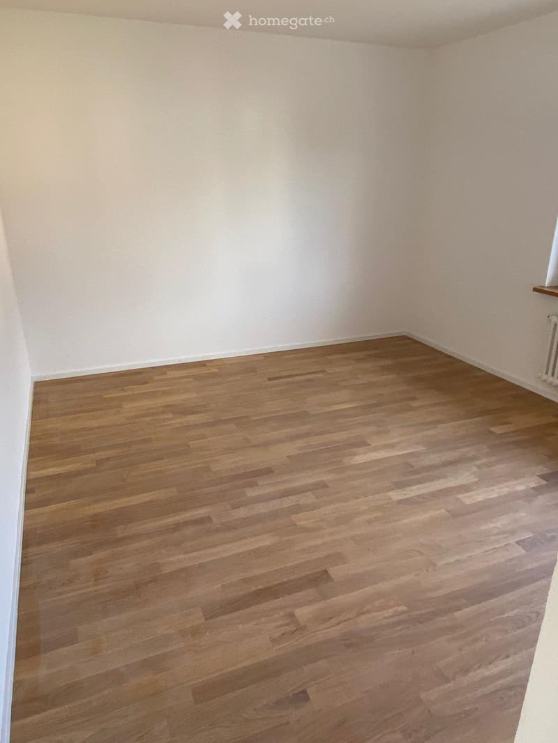 Empty room with wooden flooring and white walls, no furniture or equipment present.