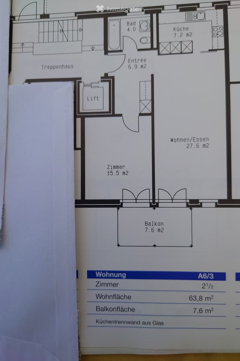 Floor plan of a 2.5-room apartment with a living/dining area, bedroom, bathroom, kitchen, entrance, staircase, lift, and balcony.