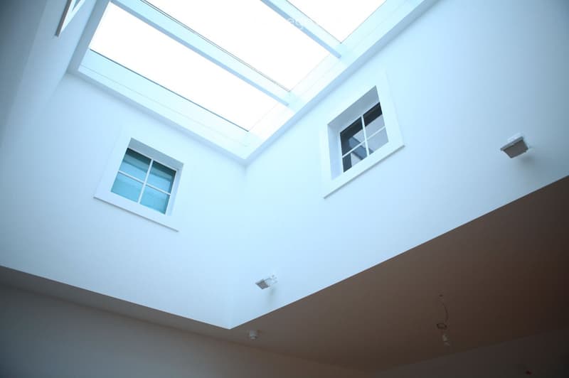 white ceiling, skylight, two windows, white walls