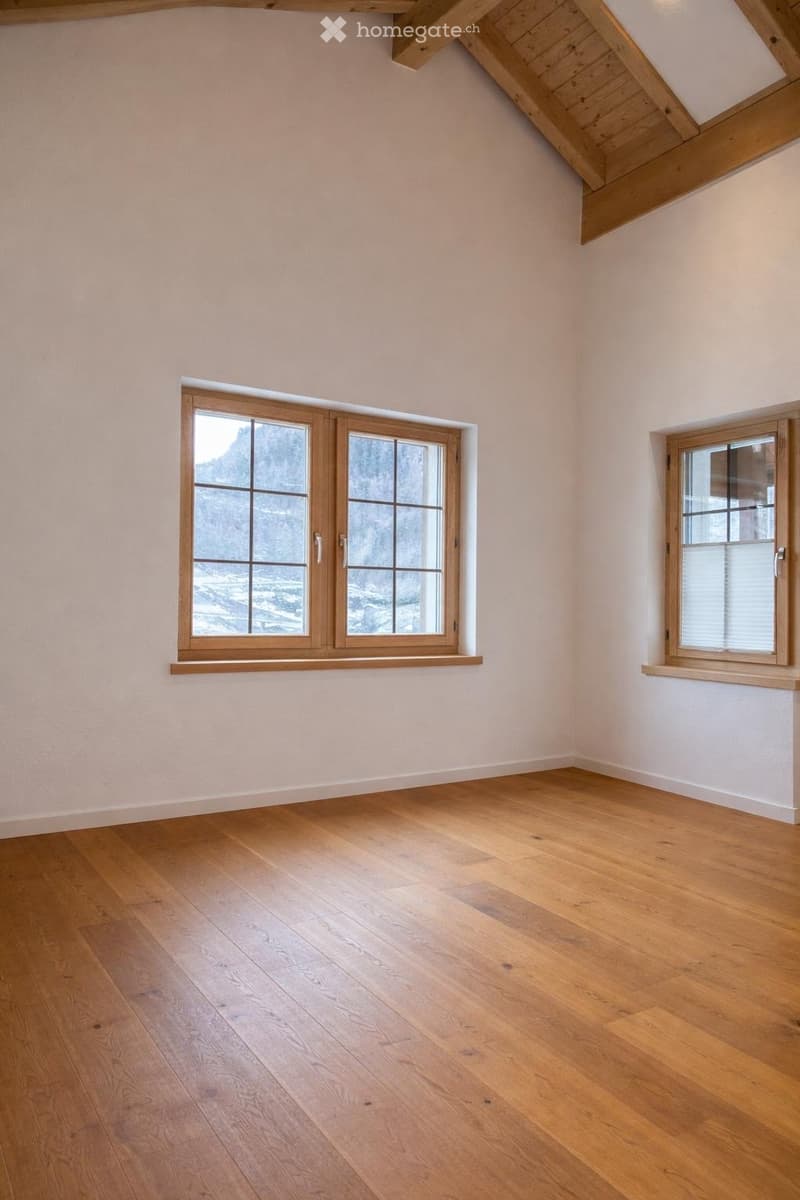 empty room, wooden floor, white walls, wooden ceiling, two windows with view