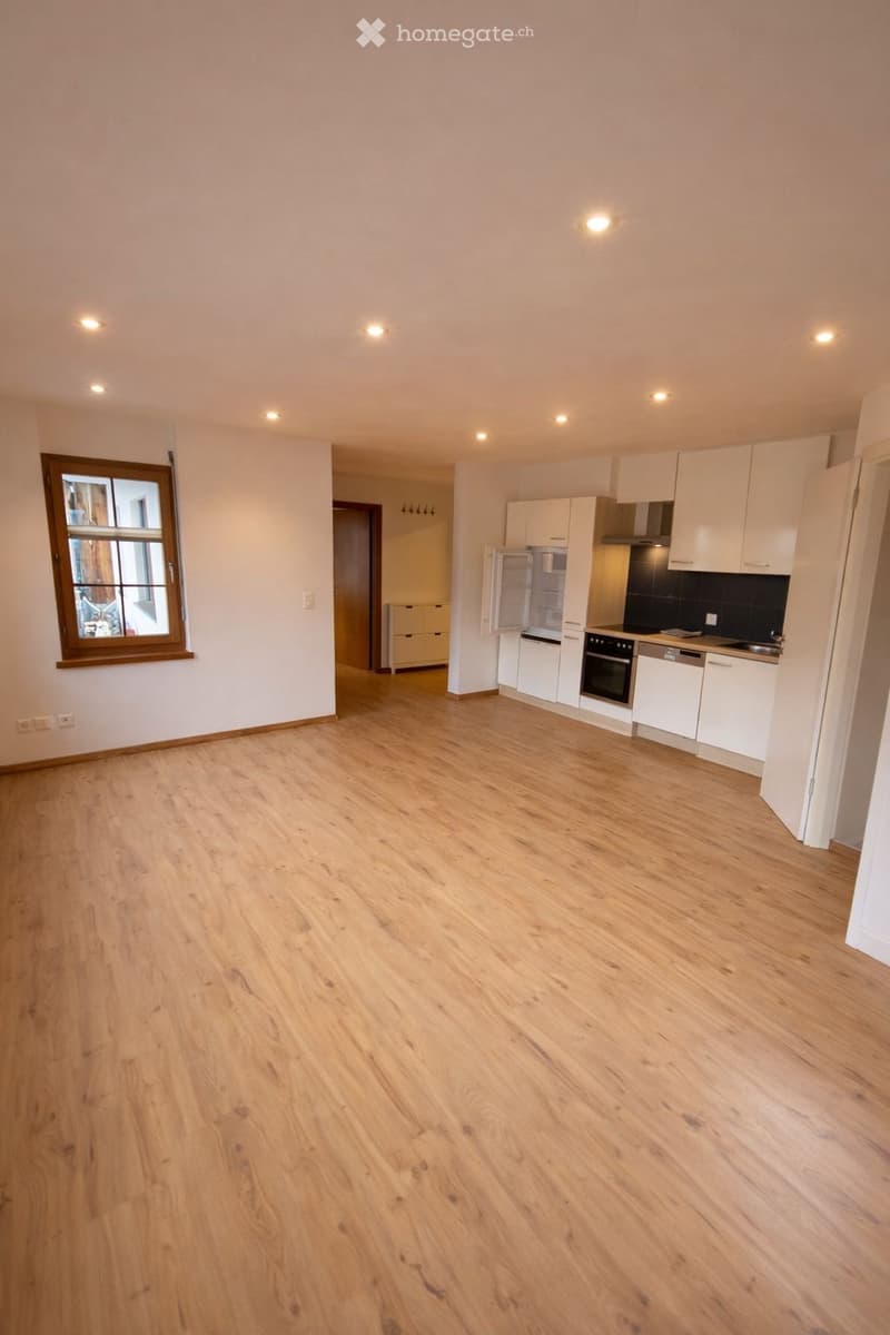 empty room, wooden floor, white walls, kitchen with appliances, window