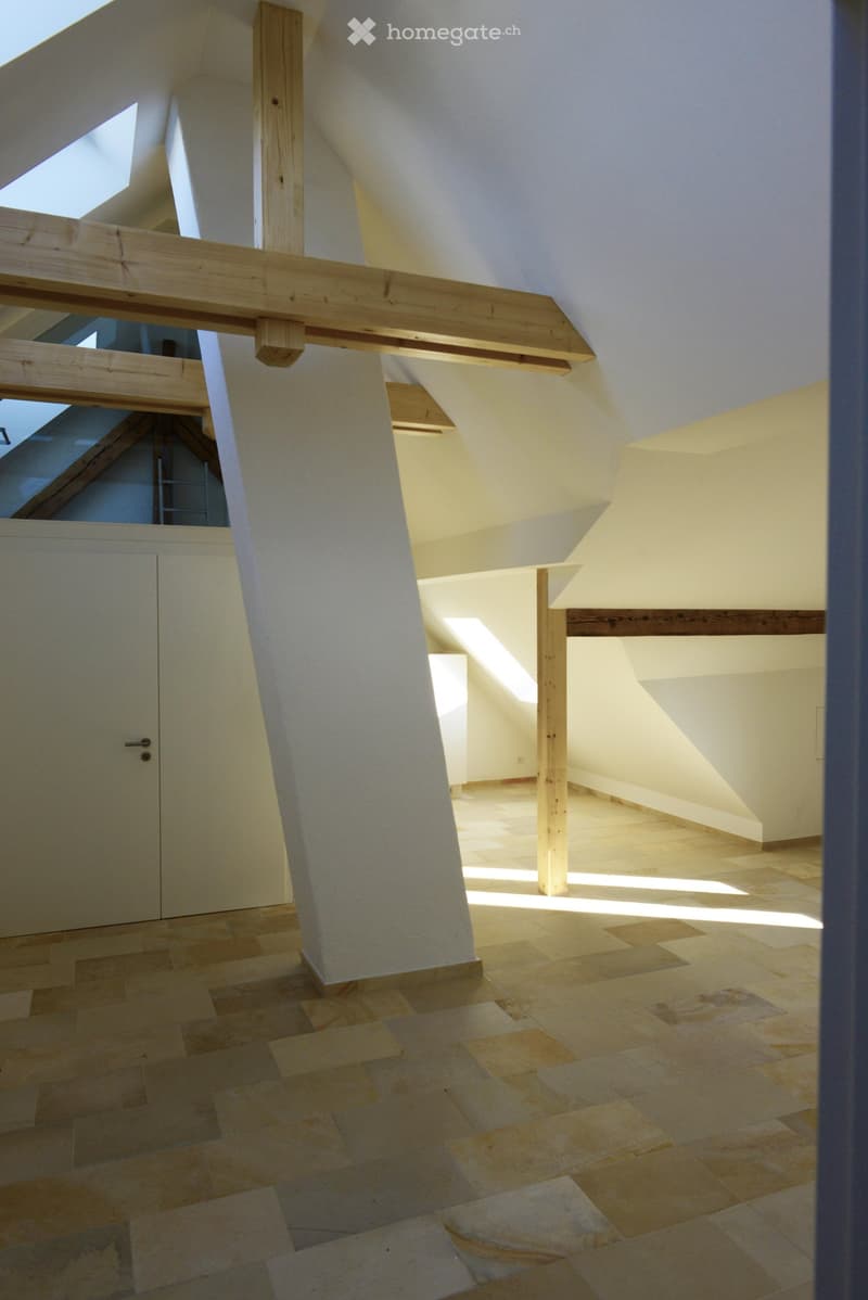 empty attic room, wooden beams, tiled floor, white walls, door