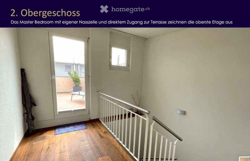 Hallway with wooden flooring, white railing, and a door leading to a balcony or terrace with a small plant visible.