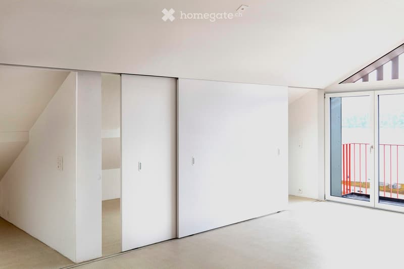 modern, minimalist room with large sliding doors, white walls, and beige floor, leading to a balcony with railings