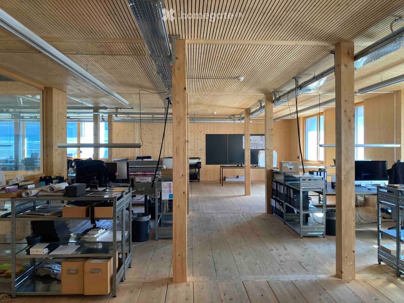 Wooden interior, large windows, wooden floor, metal shelves, office equipment