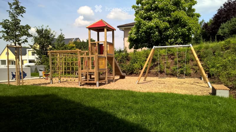 {"visible_features": [],    "type": "Garden",    "description": "Playground, wooden equipment, climbing ropes, slide, swings, gravel surface, green grass",    "localized_descriptions":        {        "EN": "Garden with a playground, wooden equipment