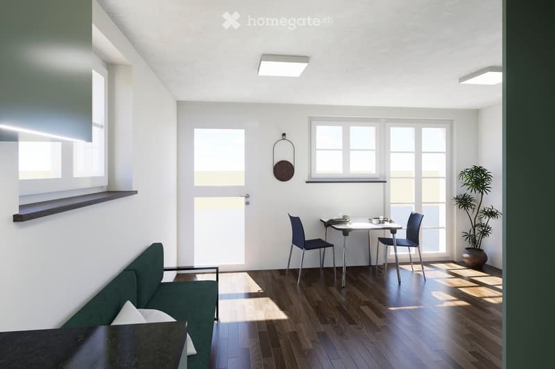 Modern living room with a green sofa, a small dining table with chairs, a potted plant, and a wall-mounted mirror. The room features large windows and wooden flooring.