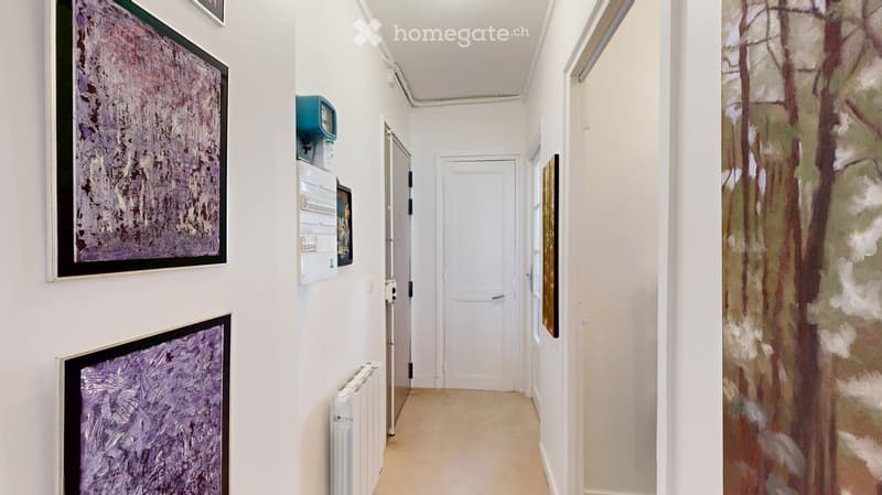 white walls, beige flooring, artwork, white radiator, white doors