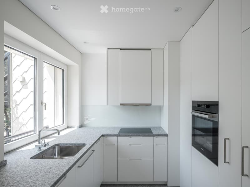 modern kitchen with white cabinets, granite countertop, stainless steel sink, electric stove, oven, and a window with a view