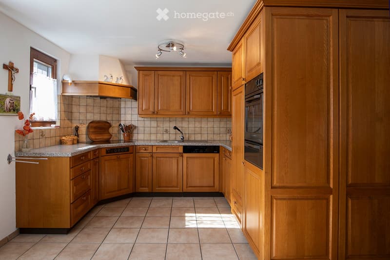 modern kitchen with granite countertop, built-in oven, wooden cabinets, granite flooring, and white ceiling with lighting