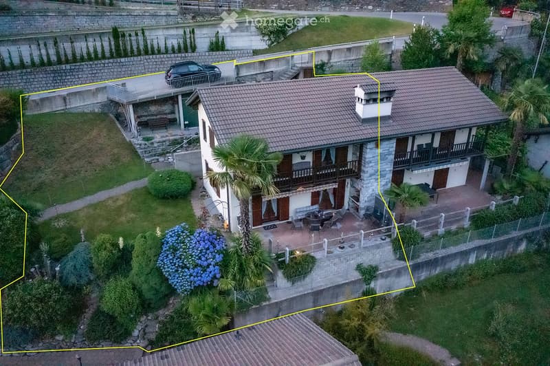 House: brown roof, white and brown walls, glass windows, chimney, terrace, outdoor dining table, car parked in front