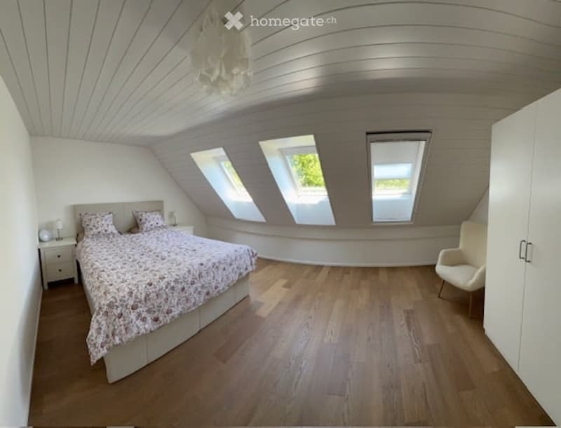 bedroom with bed, chair, and 3 roof windows
