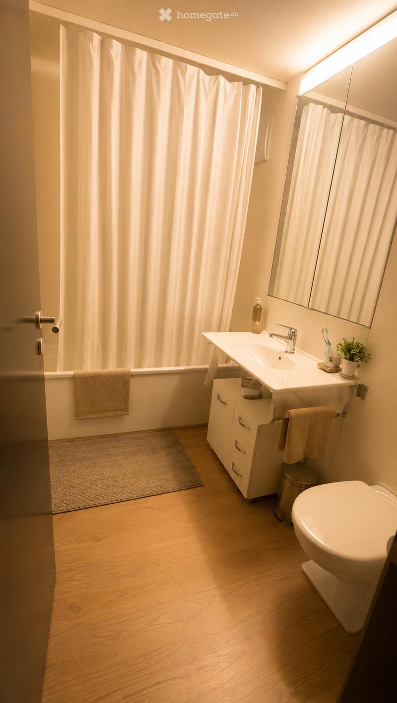 Modern bathroom with wooden flooring, white fixtures, a bathtub with a shower curtain, a sink with a mirror, and a toilet.