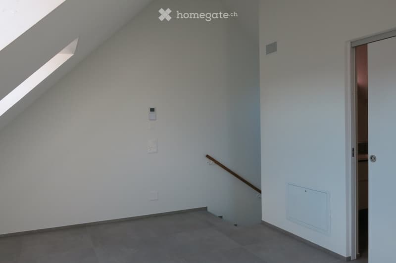 empty room, white walls, gray floor, wooden handrail, attic window, door