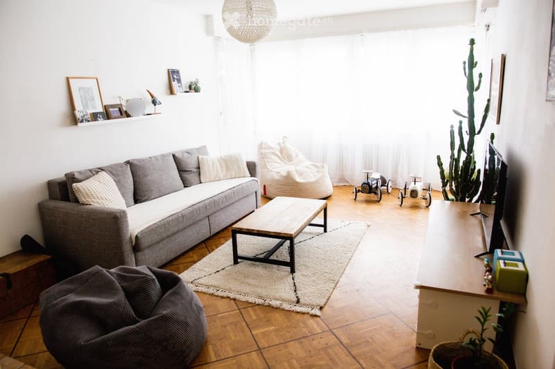{"type": "Living Room", "objects": ["sofa", "coffee table", "beige bean bag", "beige bean bag", "table", "screen", "toy car", "toy car", "picture frame", "picture frame", "picture frame", "picture frame", "picture frame", "picture frame", "picture frame",