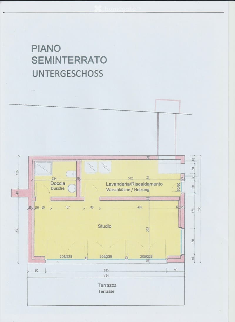 The image shows the floor plan of a semi-basement or lower-level unit. It consists of a studio space, a bathroom/shower room, and a laundry/heating room. The unit also has a terrace area.