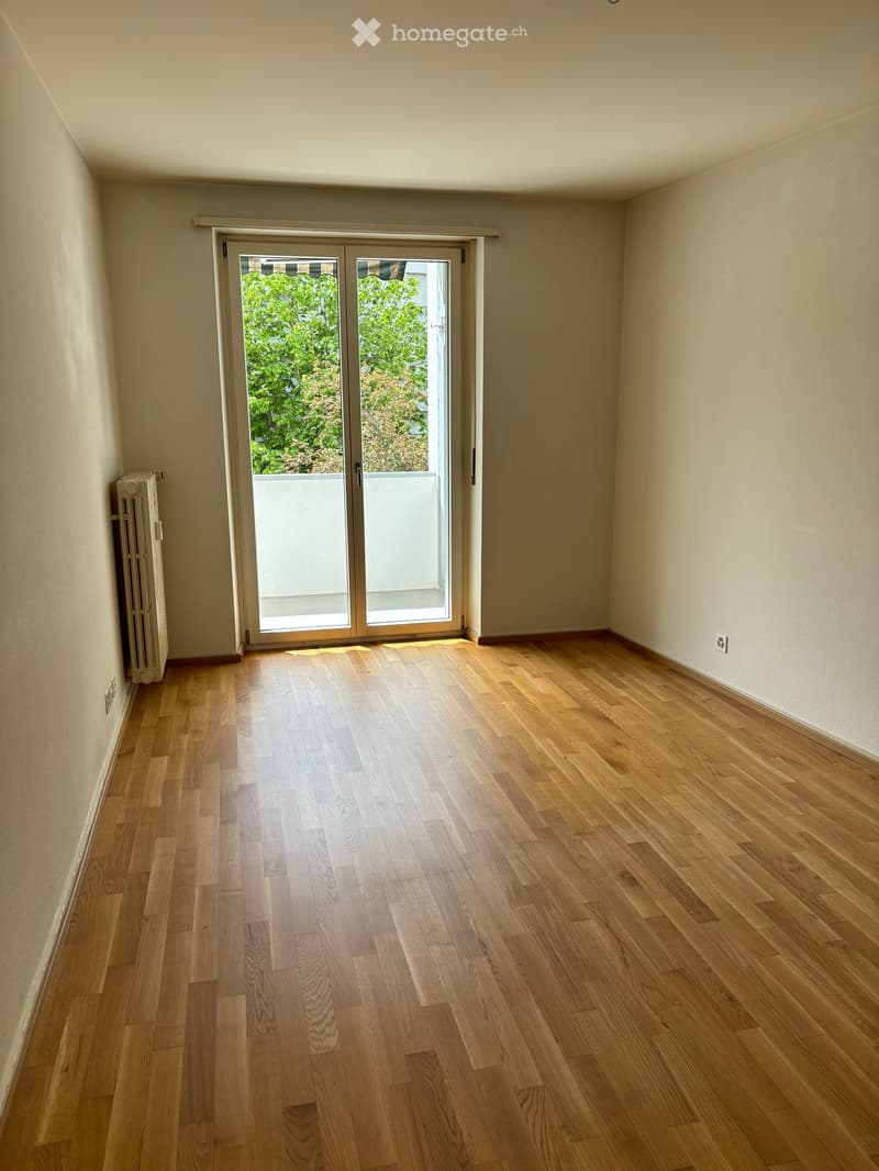 empty room, wooden floor, sliding glass door, balcony, white walls, power outlet