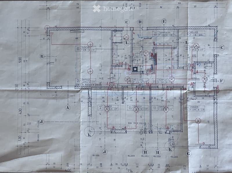 Floor plan showing multiple rooms including a garage, kitchen, bedrooms, bathrooms, and utility areas. Includes labeled dimensions and room labels.