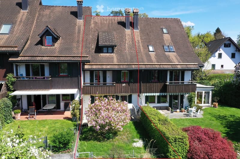 2 story house, brown roof, wooden balconies, garden, patio, awnings