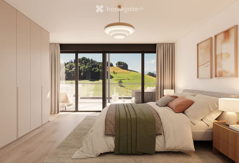 Modern bedroom with large windows offering a scenic view, featuring a bed with pillows and blankets, a nightstand with a lamp, a wardrobe, and a small table with chairs in the adjacent balcony area.