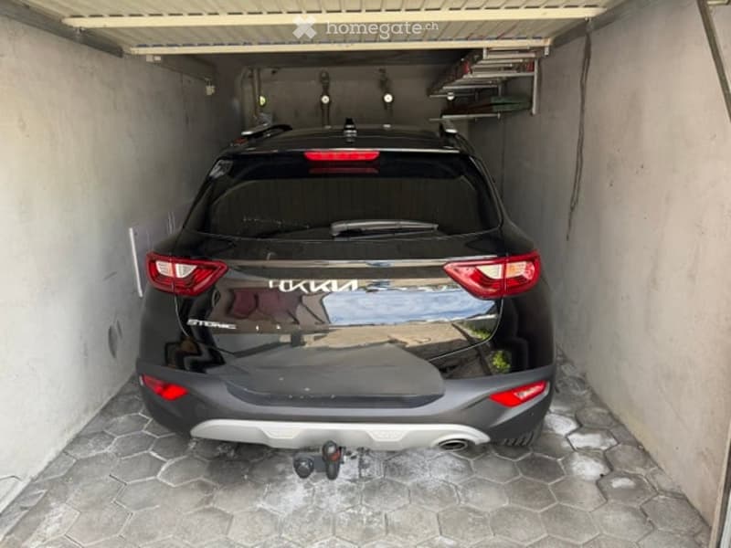 {"visible_features": ["Garage"], "type": "Garage", "objects": [], "description": "A single-car garage with a black SUV parked inside. The garage has a concrete floor and white walls.", "localized_descriptions": {"EN": "A single-car garage with a black SUV