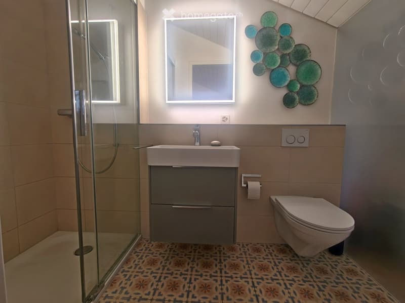 Bathroom with shower, sink, and toilet