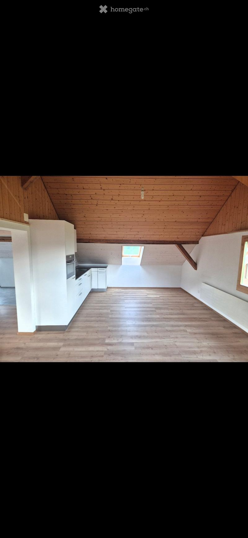 Empty room with wooden floor, white walls, and a skylight window. No furniture or equipment present.