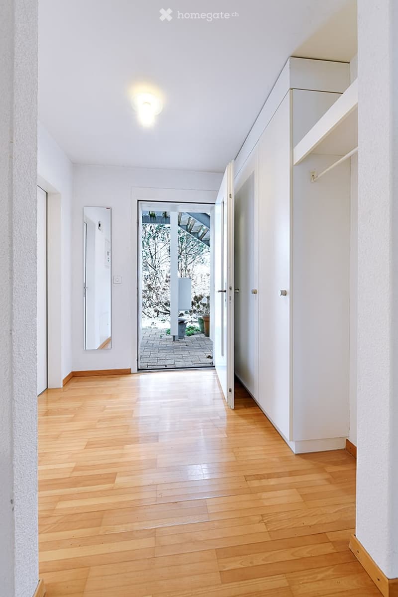 Wooden floor, white walls, white built-in wardrobe, glass door to balcony, mirror, ceiling light