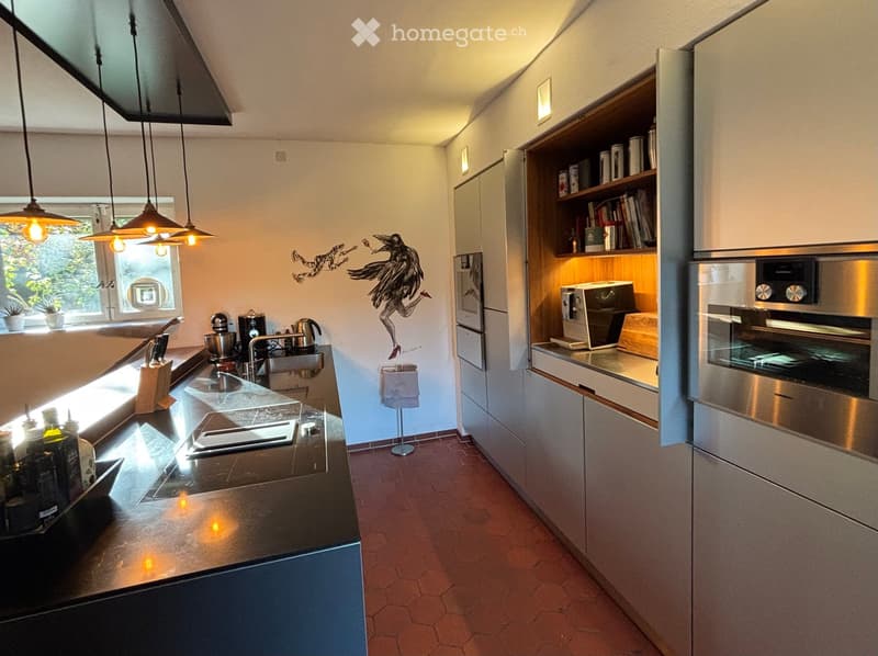 Kitchen with an island, modern appliances, tiled floor, decorative painting on the wall