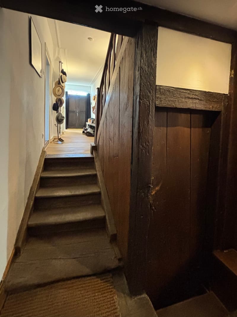 wooden staircase, exposed wooden beams, old wooden bannister