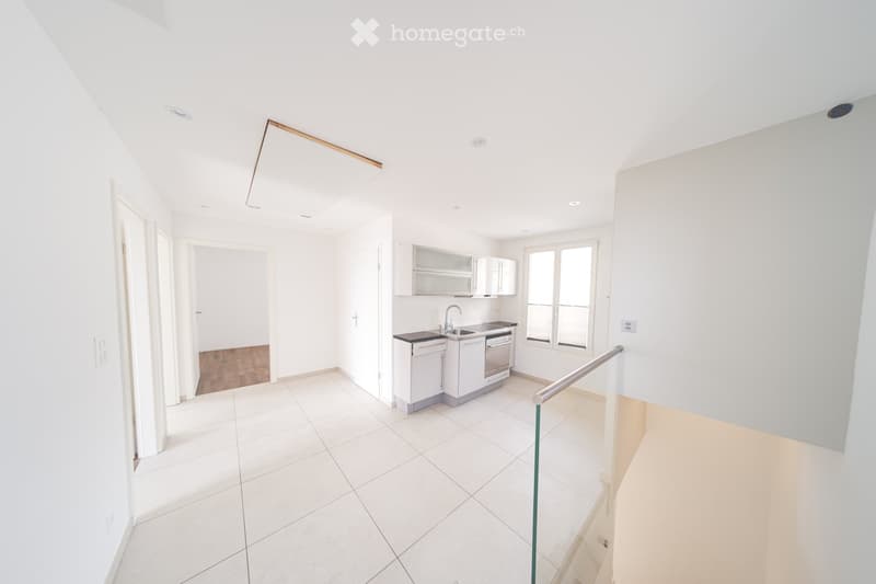 Modern kitchen with white cabinets, stainless steel appliances, and a sleek design. Features a sink, faucet, and dishwasher.