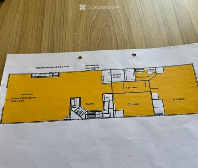 Floor plan of a mobile home with labeled rooms including living area, kitchen, bedroom, hallway, bathroom, and storage.