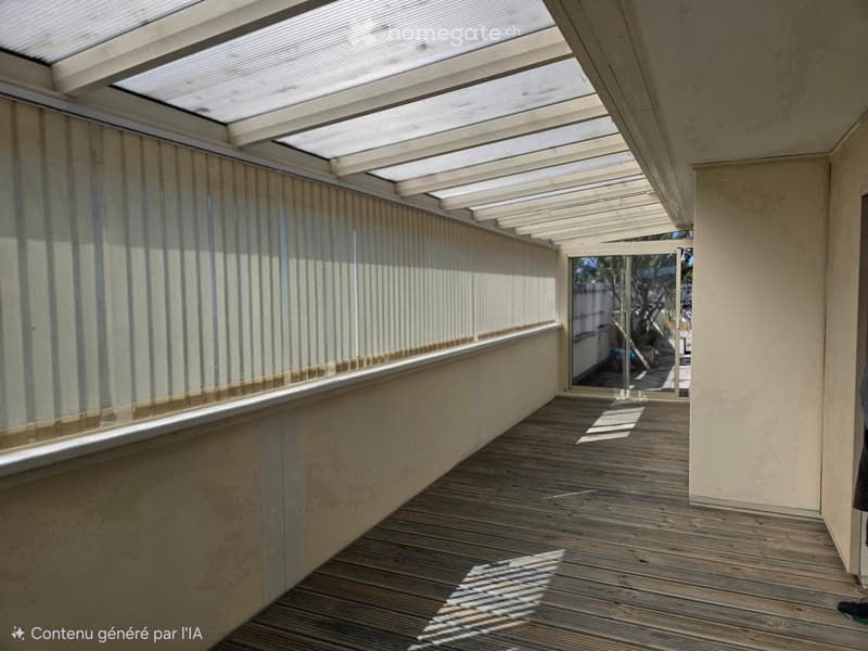 Wooden deck with a covered roof and glass panels, leading to an outdoor area.