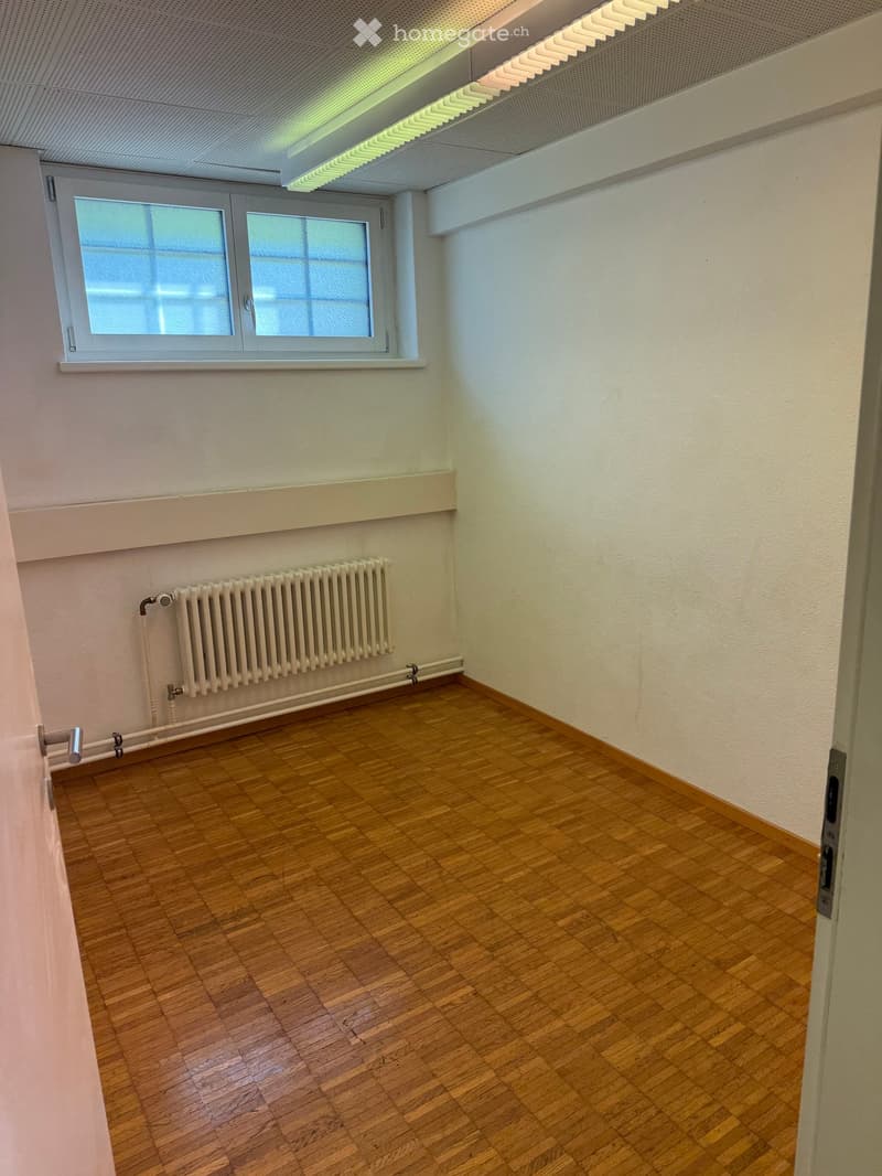Unfurnished Room. Empty room with wooden flooring, white walls, a window, and a radiator.