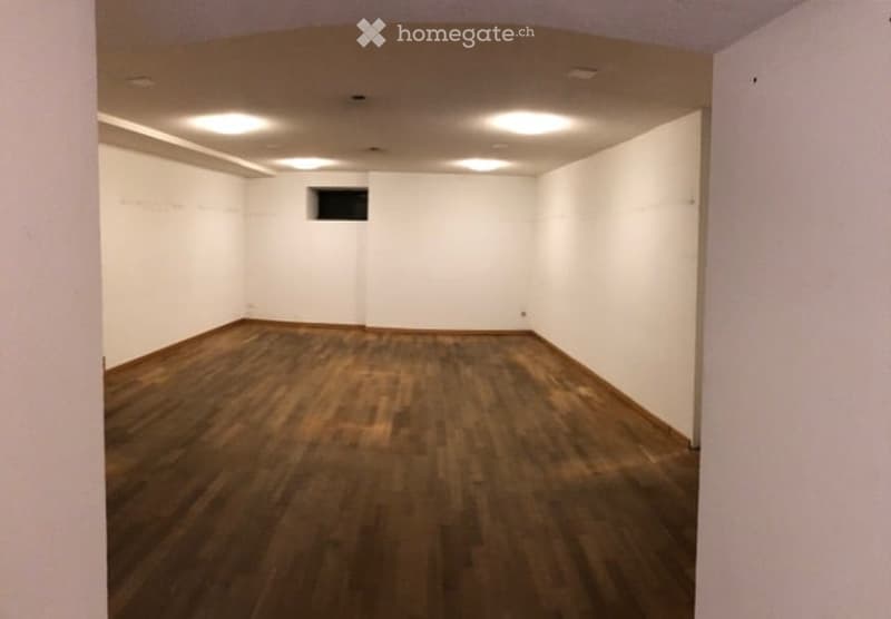 empty room, wooden floor, white walls, ceiling lights, small window