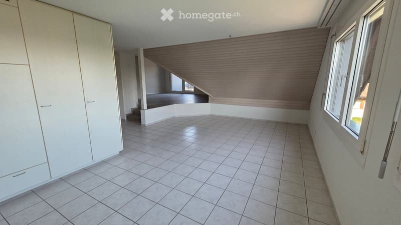 Empty room with tiled floor, white walls, large windows, and built-in closet. No furniture or equipment present.