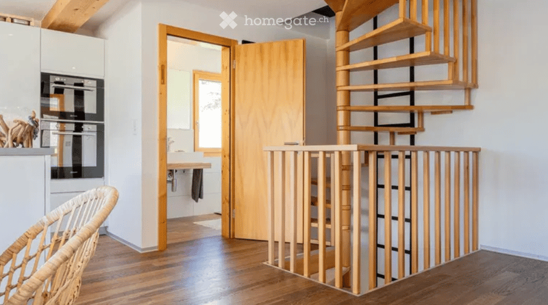 wooden floor, wooden spiral staircase, white walls, kitchen area, bathroom