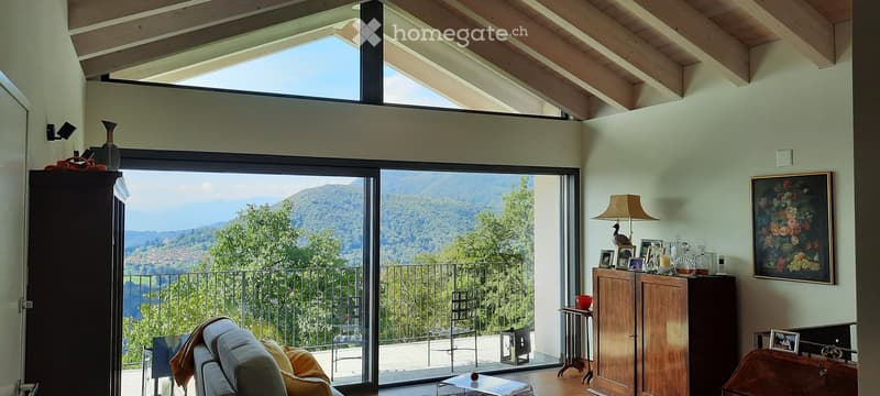 large windows, balcony, wooden flooring, white sofa with pillows, wooden cabinet, artwork on the wall, floor lamp, and various decorations