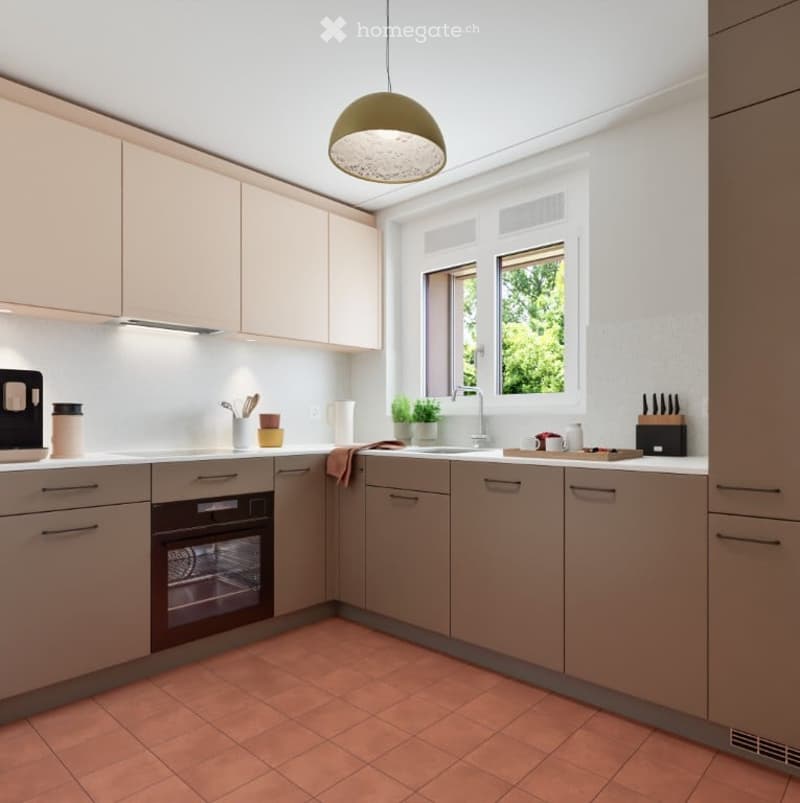 Modern kitchen with light-colored cabinets, a central island, and a tiled floor. Features include an oven, sink, and various kitchen appliances.