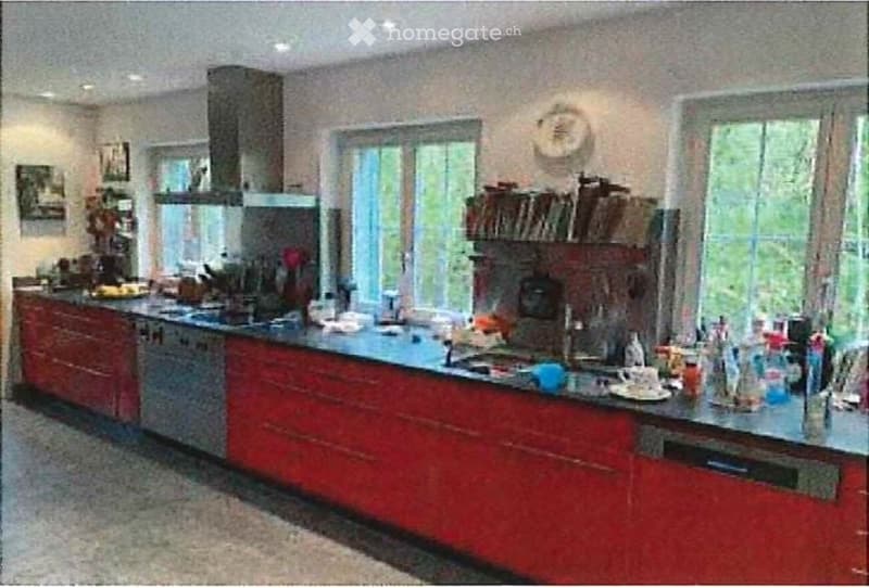kitchen with island, built-in dishwasher, gas range, red cabinets, countertops, large windows, open shelves with books