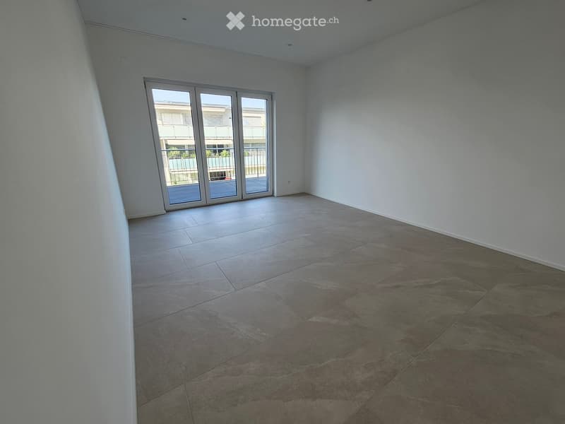 Empty room with tiled floor and large sliding glass doors leading to a balcony or outdoor area.