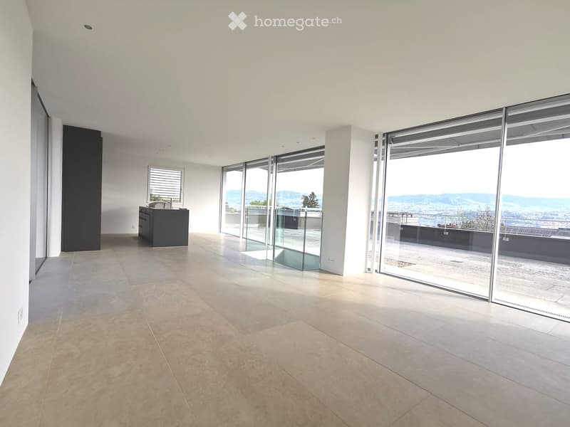 Empty room with large glass sliding doors leading to a balcony, tiled floor, and a small black cabinet with a sink.