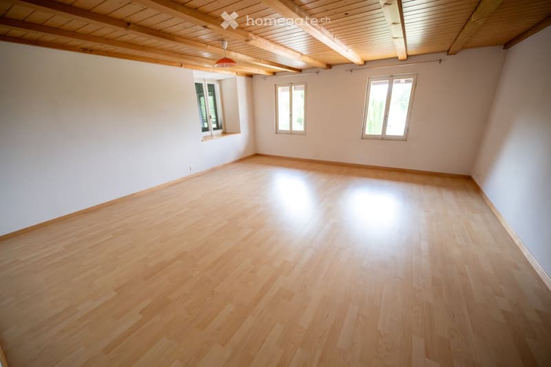 empty room, wooden floors, white walls, wooden beams, windows