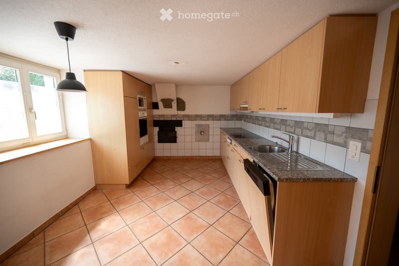 modern kitchen with tiled floor, sink, oven, cabinets, countertop, ceiling lamp