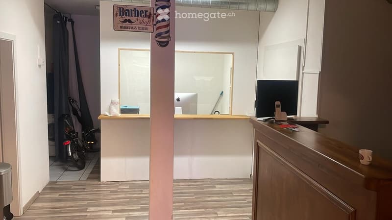 barber shop with reception area, desk, computer, bicycle, curtain