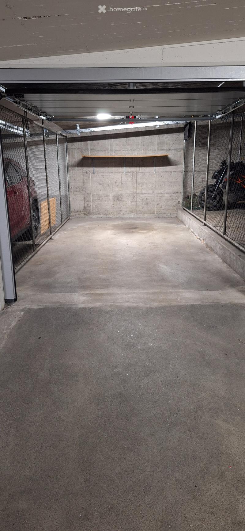 {"type": "Garage", "objects": [], "description": "Underground parking space with concrete floors and walls, metal fencing, and a single shelf. A red car and a motorcycle are partially visible behind the fencing.", "localized_descriptions": {"EN": "Undergr