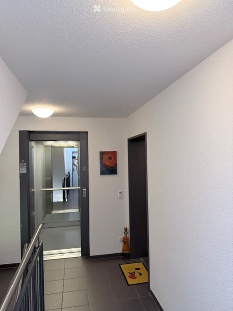 Tiled floor, white walls, elevator, picture, open door, metal railing